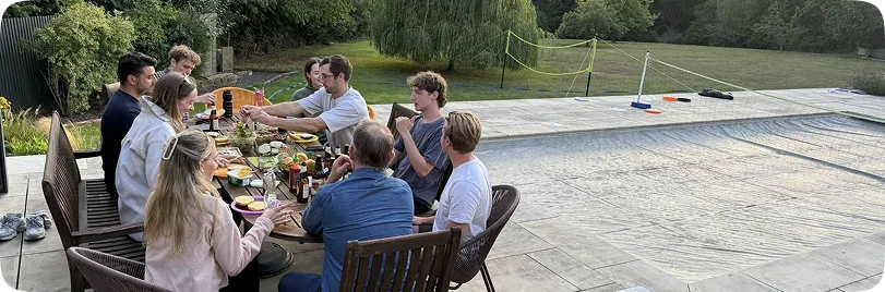 Kana Earth team sharing a meal outdoors in a garden